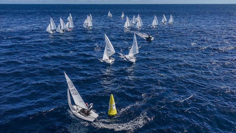 Fleet of sailboats competing in Lanzarote waters with yellow racing mark, international regatta