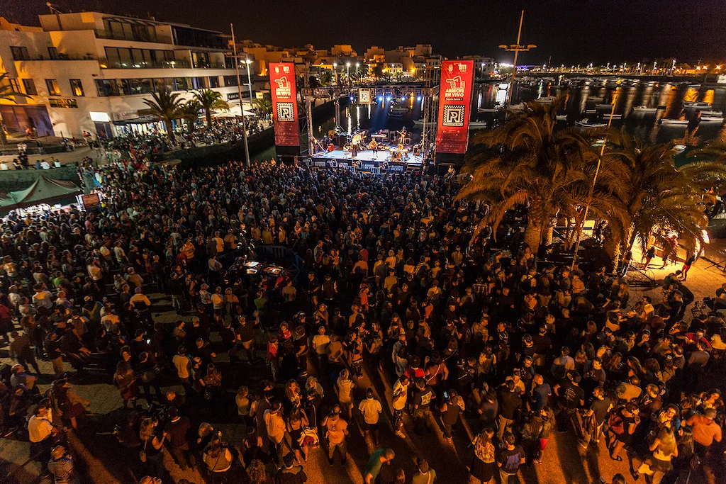 Crowd following an Arrecife en Vivo street parade through central Arrecife, Lanzarote